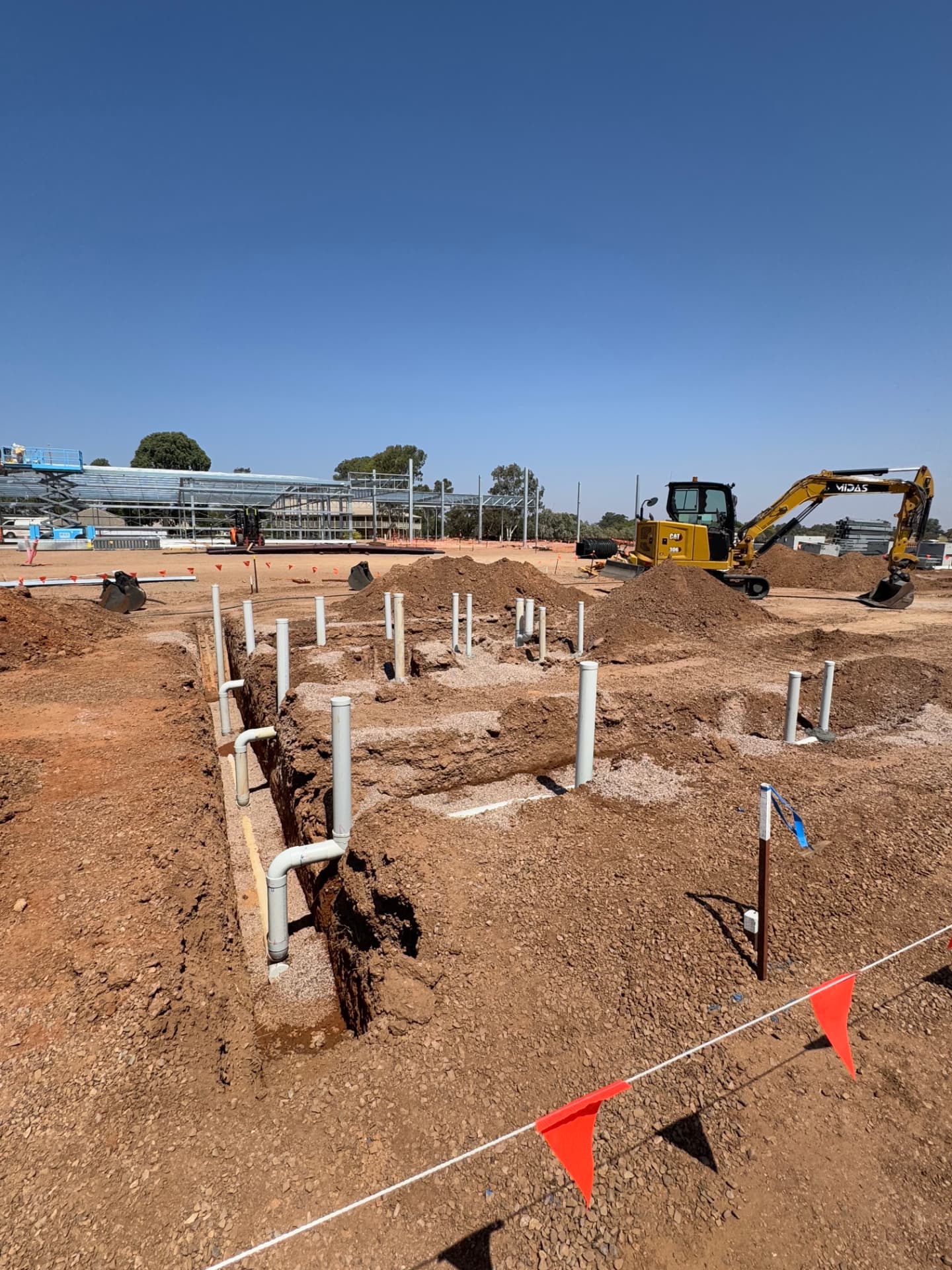 Commercial construction plumbing rough-in in trench